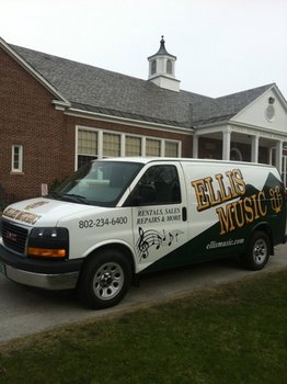 Photo of an Ellis Music van parked in front of a school